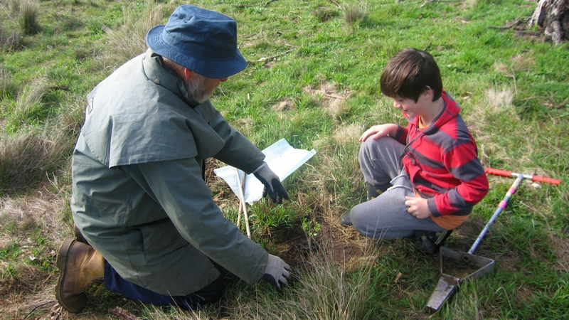 Bill Honey, local farmer and past president of BFS Landcare, imparting his knowledge to a young tree planter